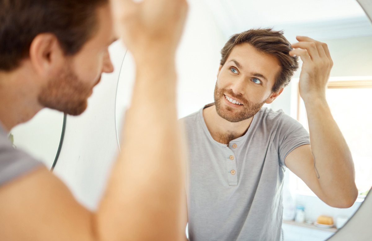 Man-admiring-results-of-PRP-hair-restoration