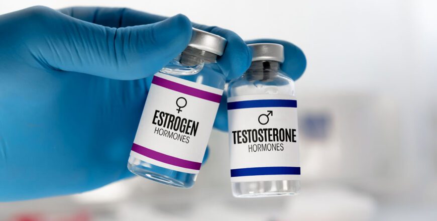 gloved-hand-holding-two-hormone-medication-vials