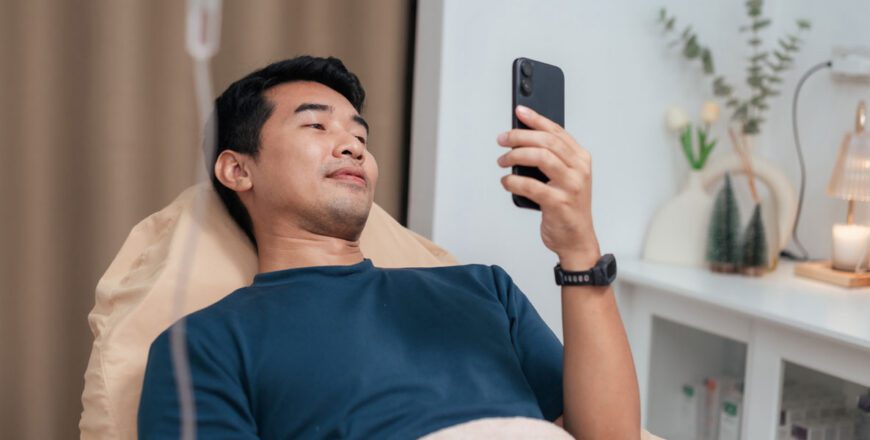 man-lying-awake-in-bed-at-night-looking-at-his-phone